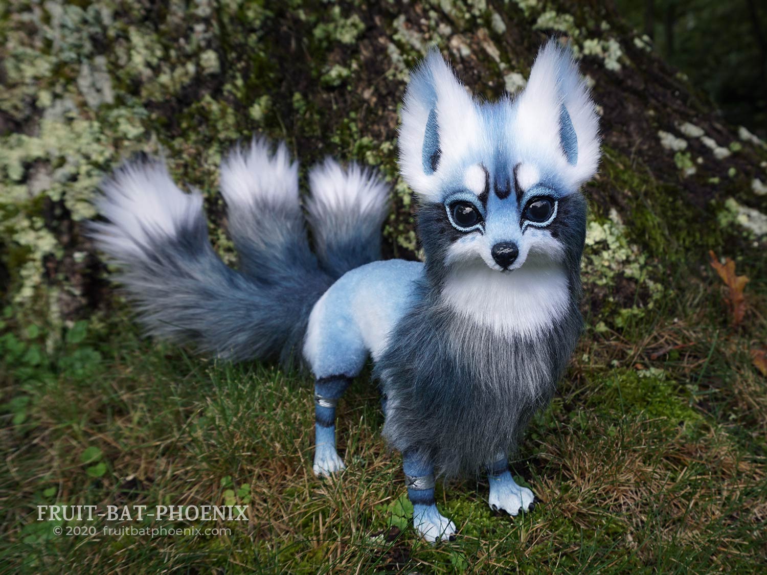 A blue kitsune art doll with three tails