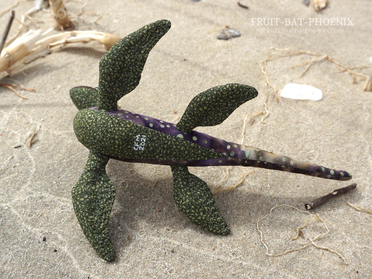 purple-green nessilet plush, underside view