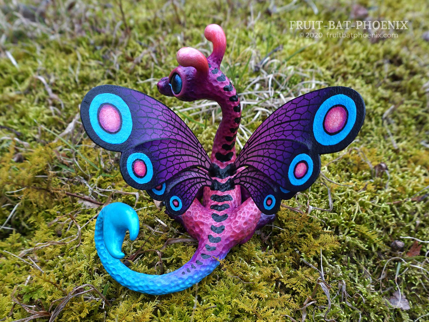 purple and blue dragon sculpture with spotted butterfly wings