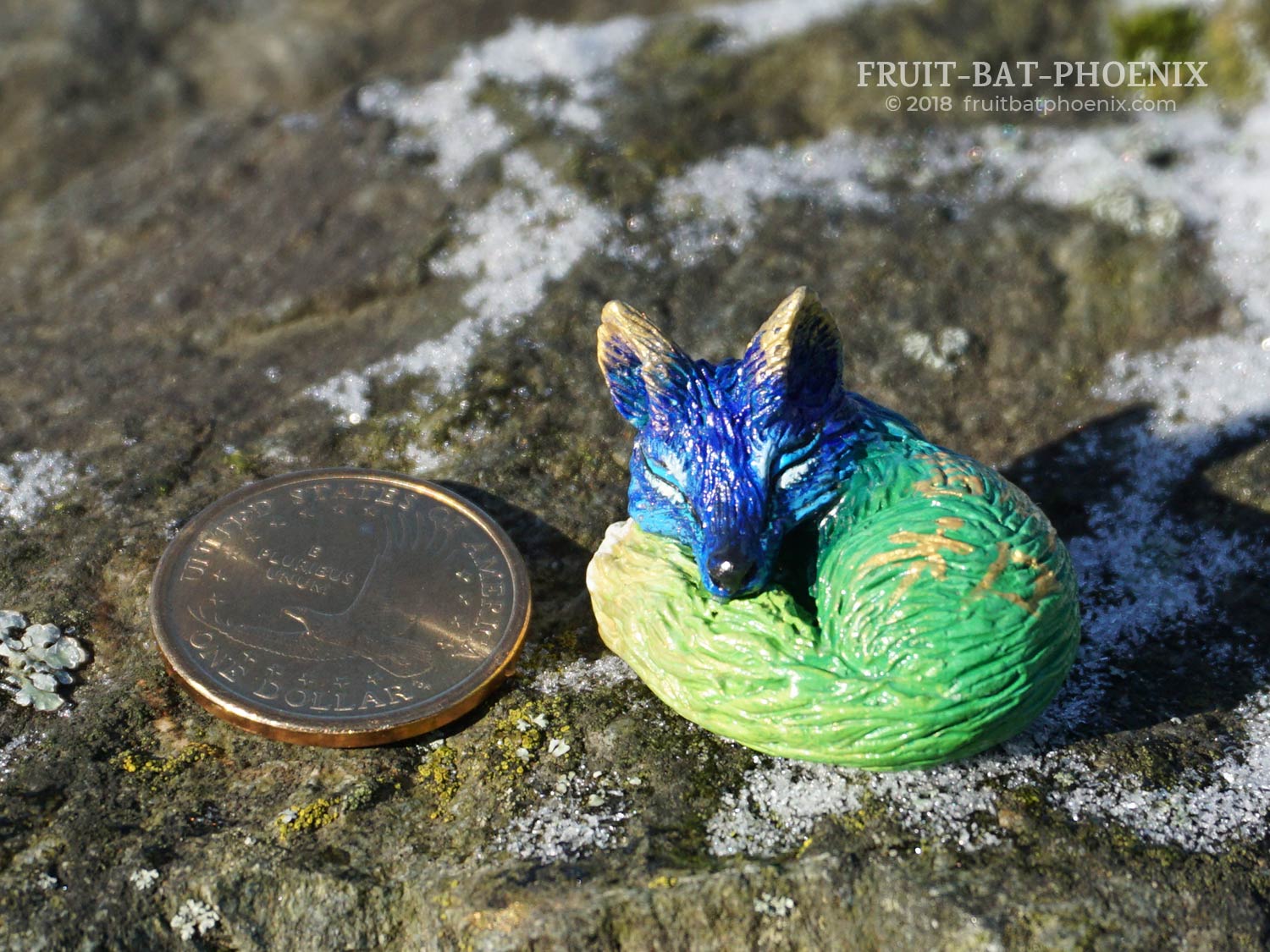 zenko the tiny fox with coin for scale
